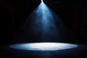 A spotlight shines on a stage with smoke photo