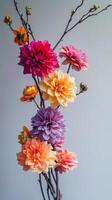 A vase with colorful flowers on a gray background photo