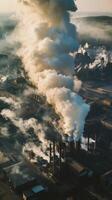 An aerial view of a factory with smoke coming out photo
