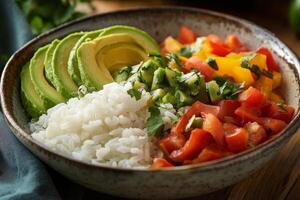 Mexican rice bowl with avocado, tomatoes, and rice photo