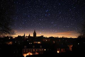 The night sky is filled with stars and the city is lit up photo