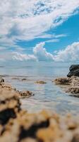 A rocky beach with water and clouds photo