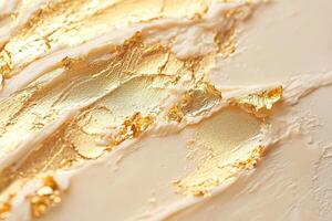 Creamy background enhanced with streaks of genuine gold leaf photo
