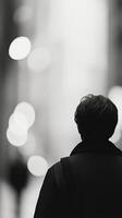 Silhouette of a person standing among foliage in a misty setting at dusk photo