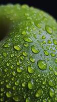Fresh green apple with rain droplets on its surface hanging on the tree branch photo