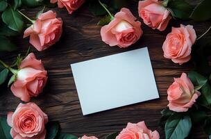Pink roses surround a blank card on a wooden table in a cozy setting during the daytime photo