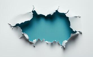 Torn paper reveals bright blue background with jagged edges and texture photo