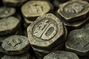 Stack of ancient looking stones with carved symbols displayed closely photo