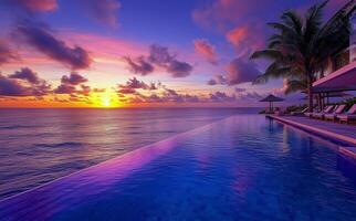Sunset over tranquil ocean viewed from infinity pool at luxury resort photo