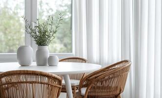 Elegant dining area with natural light and modern decor featuring a round table and woven chairs photo