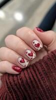 A woman's hand with red and white hearts on it photo