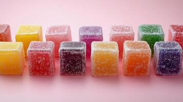 Colorful gummy candies arranged on a pink background in a creative and appealing manner photo