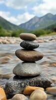 Stacked river rocks display balance in nature near mountains photo