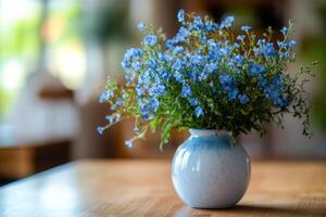 A vase with blue flowers sitting on a table photo