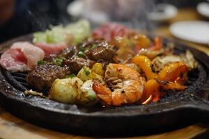 A grill with meat and vegetables on it photo