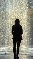 A woman standing in front of a fountain photo