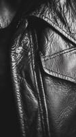 Close up view of black leather jacket with pocket detail photo