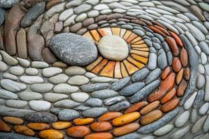 Intricate stone mosaic pattern displaying a swirling artistic design photo