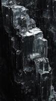 Vertical composition showcases a dark crystalline mineral structure closely photo