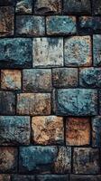 A colorful stone brick wall with various textures stands tall photo