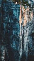 A vertical shot of a majestic rock cliff face photo