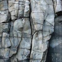A close up view of a rugged rocky cliff face photo