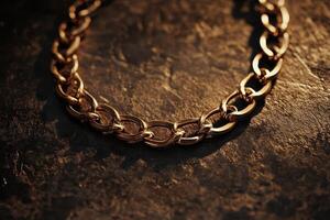 Gold chain necklace displayed on a textured dark surface photo
