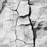 Cracked white rock formation with visible crevices and textures photo