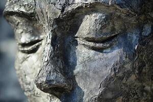 Sculpture of a serene face with eyes closed in contemplation photo