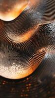 Metal sculpture displaying curving lines with an orange glow photo
