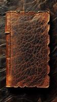 Distressed brown leather journal with jagged edges lies on surface photo