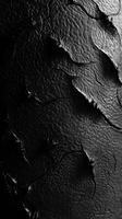 Close up of black cracked leather texture fills frame photo