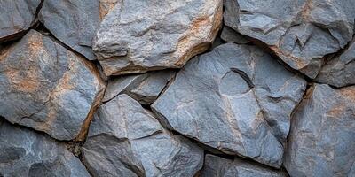 Irregularly shaped gray rocks form a textured surface pattern photo