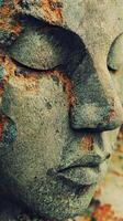 Stone buddha face with weathered textures and serene expression photo