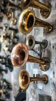 A collection of antique brass horns adorn a textured wall photo