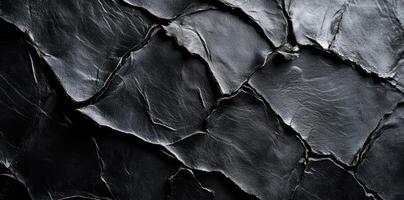 Black textured paper creates an abstract and dramatic background photo