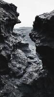 Jagged rocks frame a stark landscape in monochrome tones photo