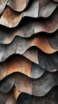 Overlapping leather pieces create an abstract wavy textured background photo