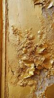 Close up view of decaying gold painted wall surface photo