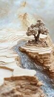 Miniature layered landscape with a lone tree and flowing river photo