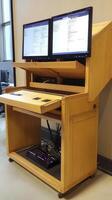 A computer desk with two monitors on top photo