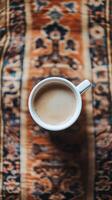 A cup of coffee on a rug by jessica klein for stocksy united photo