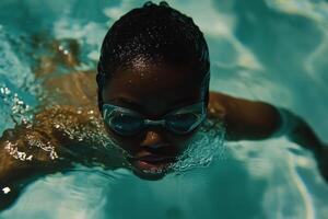A woman in goggles swimming in a pool photo