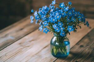 Forget me not flowers in a vase on a wooden table photo