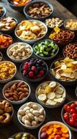 A variety of different types of snacks are arranged in bowls photo