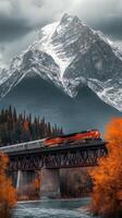 A train traveling over a bridge in the mountains photo