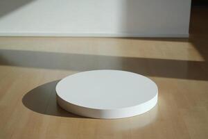 A white round table sitting on a wooden floor photo