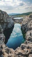A pool in the middle of a rocky area photo