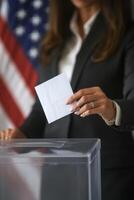 A professional woman speaks at a podium with an American flag backdrop at a public event photo