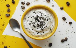 Creamy dessert with coffee beans and crushed toppings on a bright yellow background photo